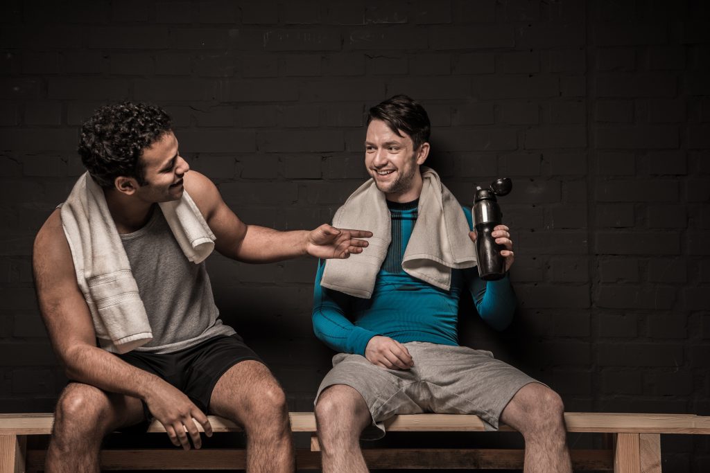 handsome male athletes resting and conversing at g 2024 11 19 18 16 33 utc