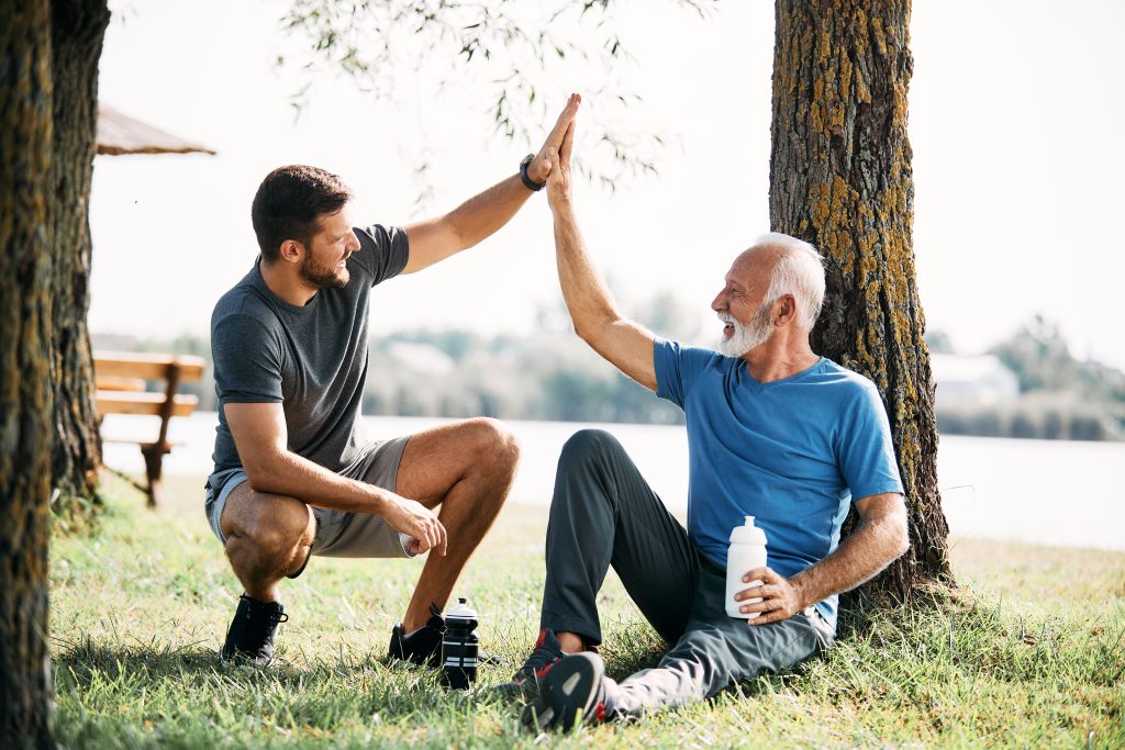 adult and senior man high five outdoors 2026 03 16 03 29 11 utc