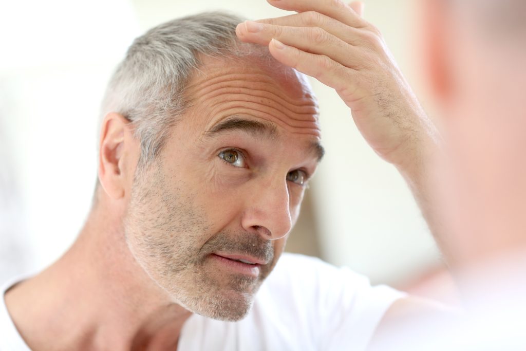 adult man examining graying hair in mirror 2026 04 13 23 58 45 utc